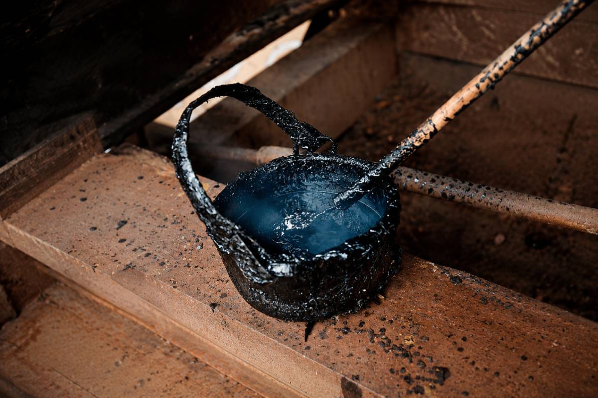 A bucket of caulking pitch, one of the practical materials used to protect wooden boats.