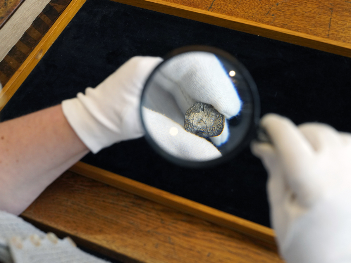 One of the coins seen through a magnifying glass.