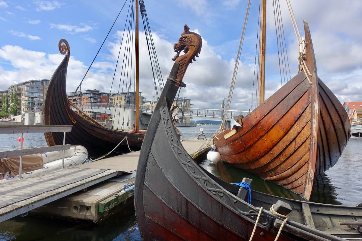 Replica Viking ships Saga Oseberg, Saga Farmann, and Sæheimr are moored at the harbor in Tønsberg, Norway.