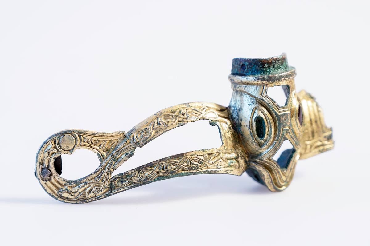 Danish archeologists have identified two helmet fragments from 650–750 CE, confirming they belong to a single Norse helmet once decorated with gold and a red garnet.