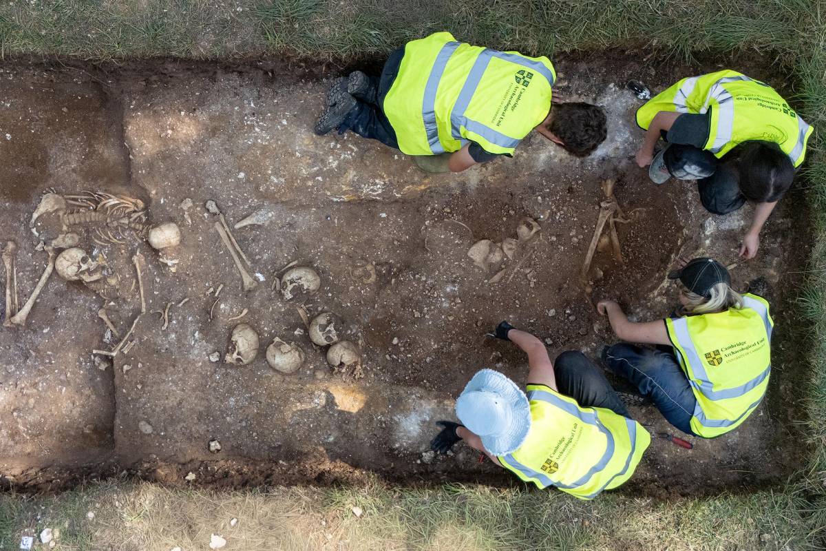 Archeologists and student volunteers excavate a Viking Age burial pit at Wandlebury near Cambridge, England, where at least ten men were found in a single grave.